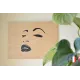 Painting of a woman's face chantourné in birch.