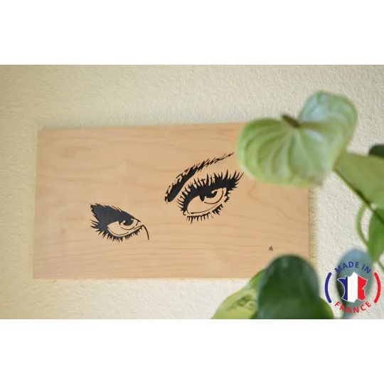 Painting of the eyes of a woman chantourné in birch.